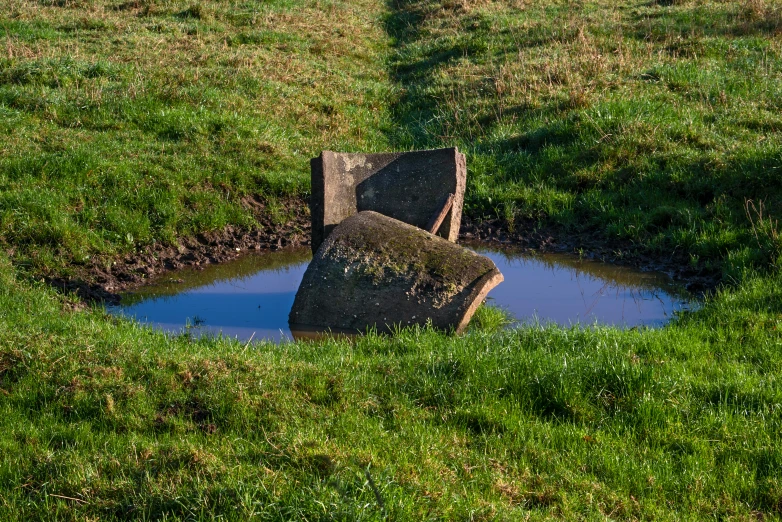 the remains of a stone pillar in the field