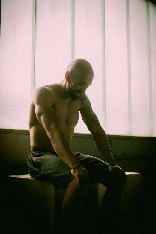 a man sitting alone, in a dark room