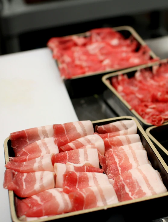 raw meats are packaged and lined up to be cooked