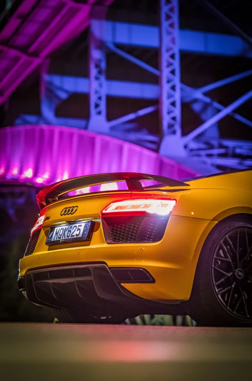 the back end of a yellow sports car