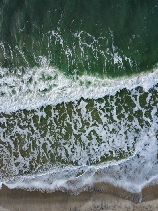 the waves are coming up onto the beach shore