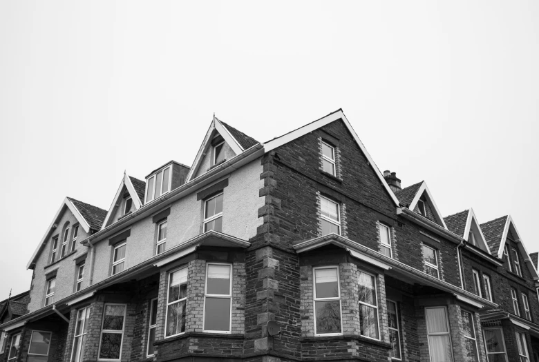 the front of a large brown building with many windows