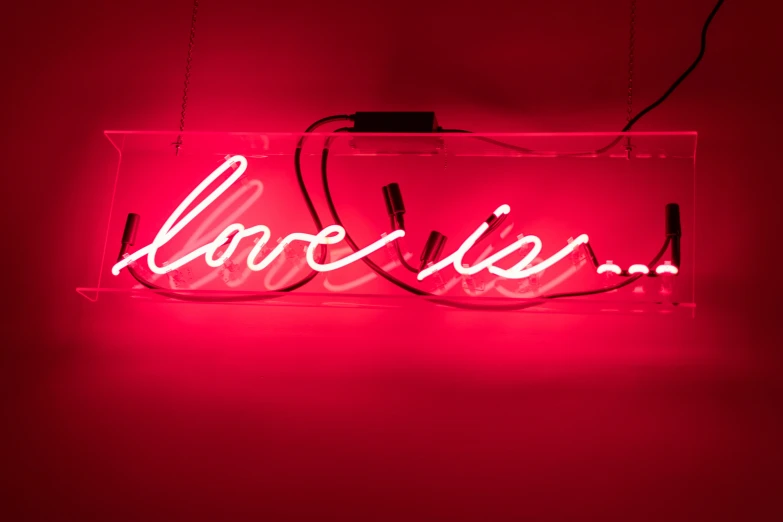 this is a red neon sign with a light on