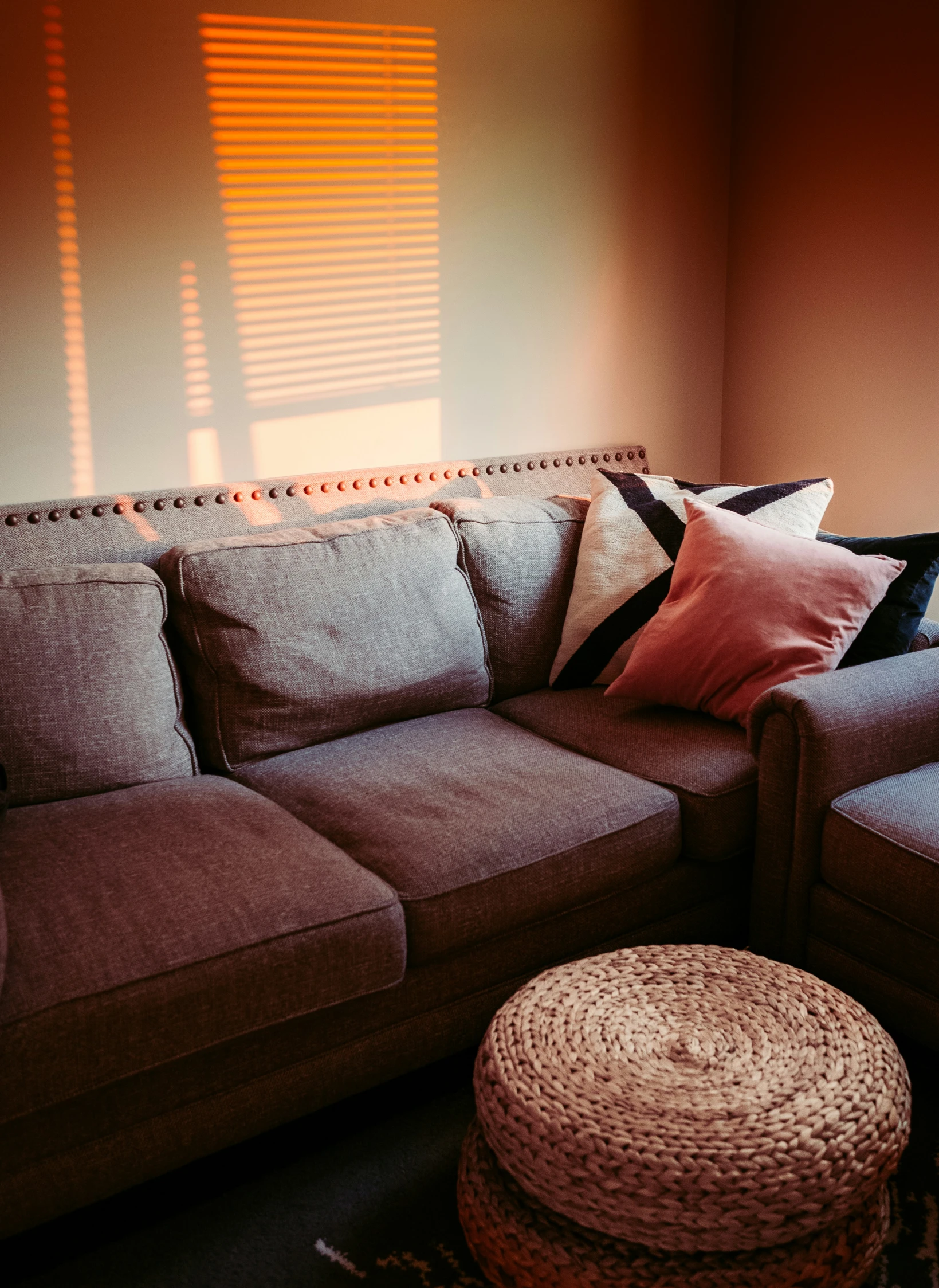 a sofa and footstool are in a room