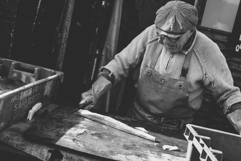 a woman in black and white working at a table