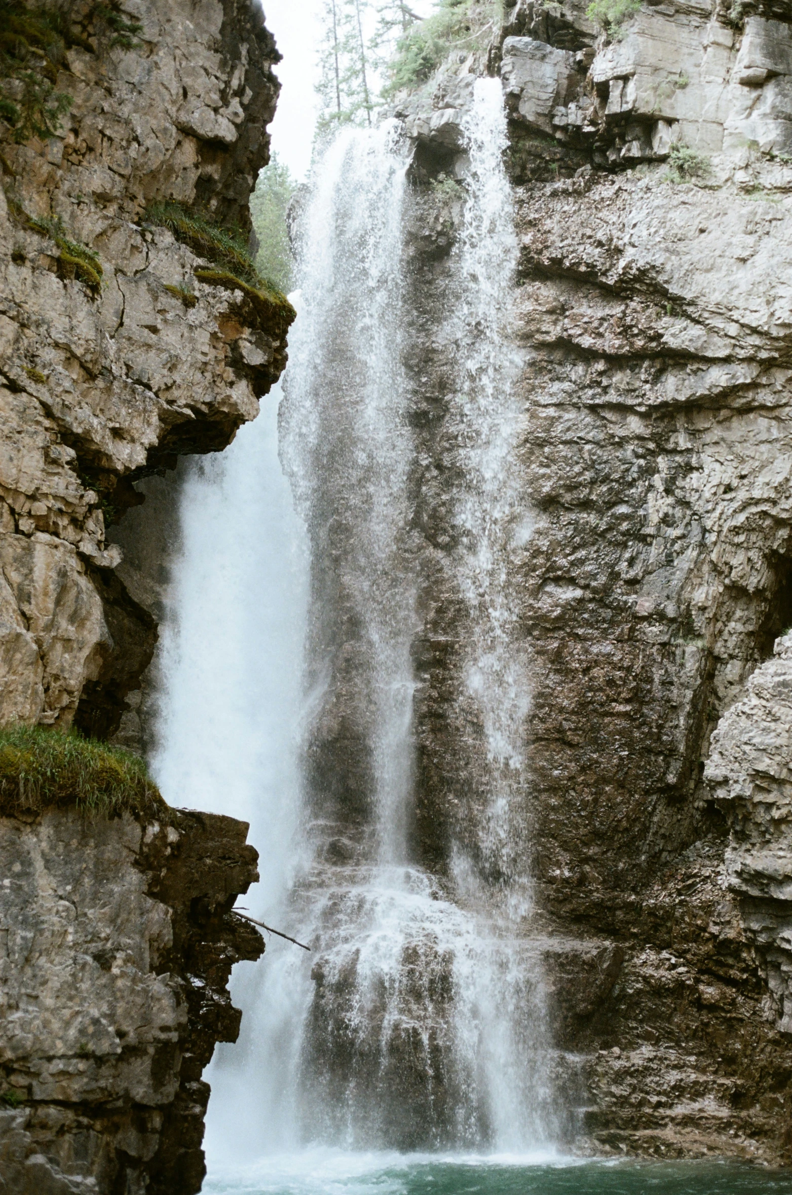 an uplift water fall that has just come down and is falling over rocks