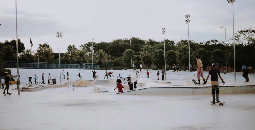 people gathered at the skatepark in an old po