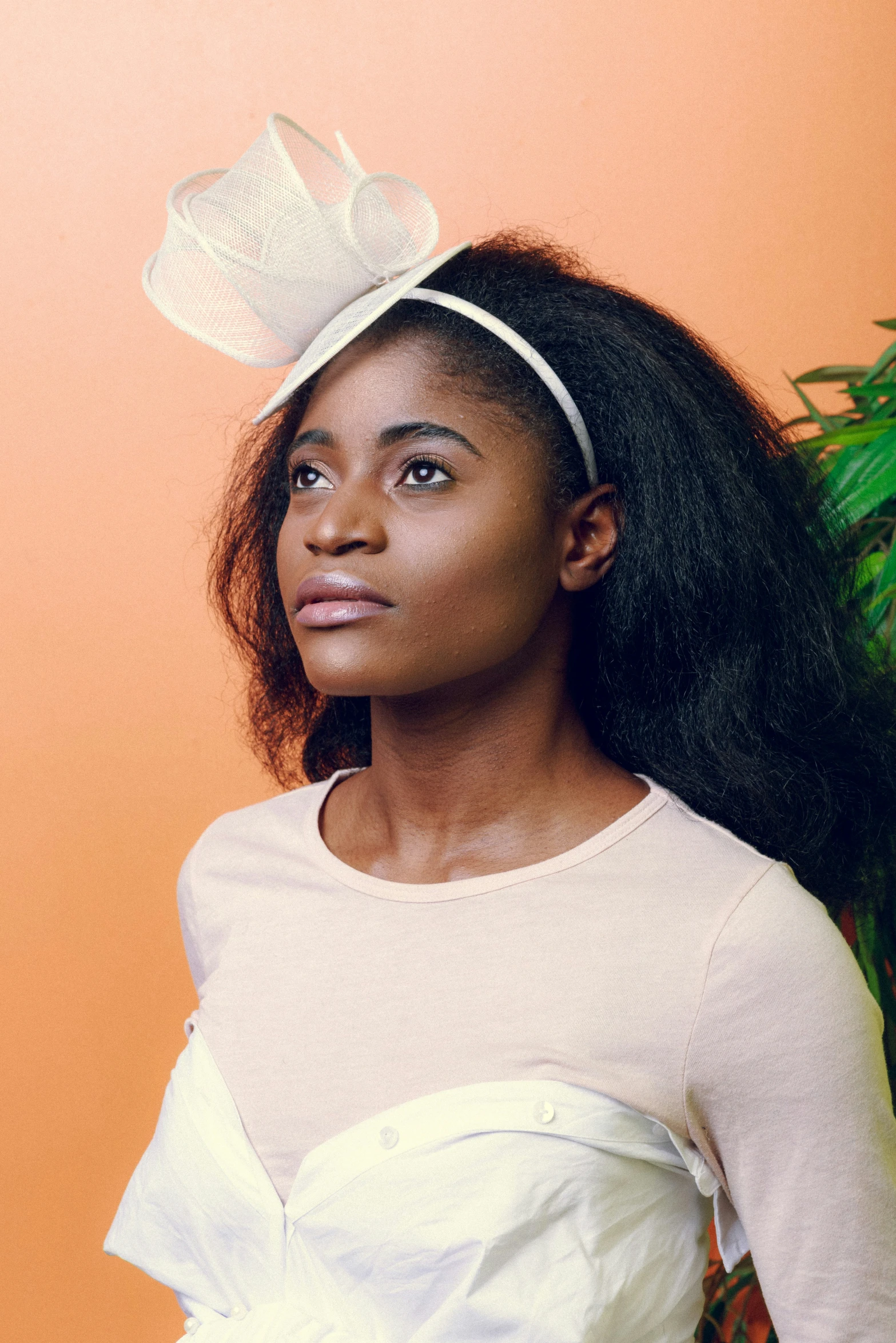 a young woman with a very long brown hair and a big white hat