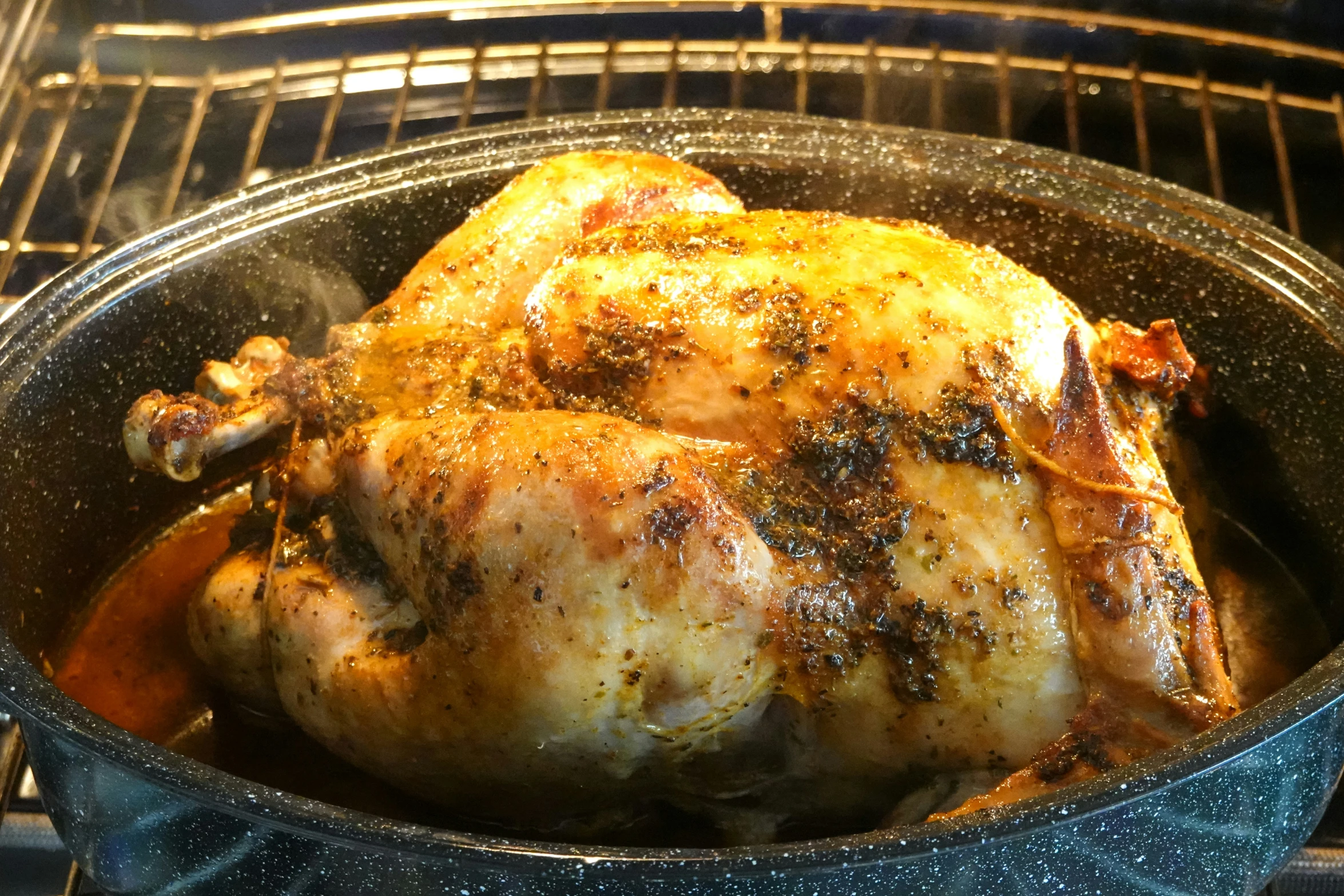 a chicken sitting inside of an oven next to a stove