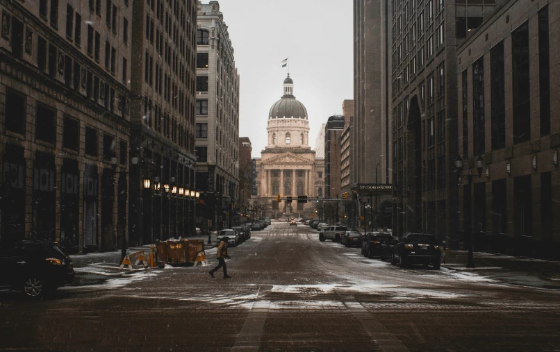 a deserted street with a building in the background