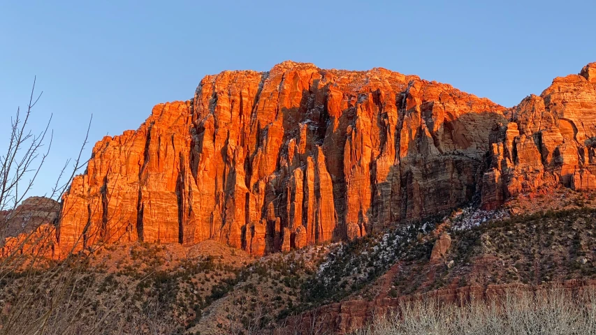 a large mountain range with a rock face