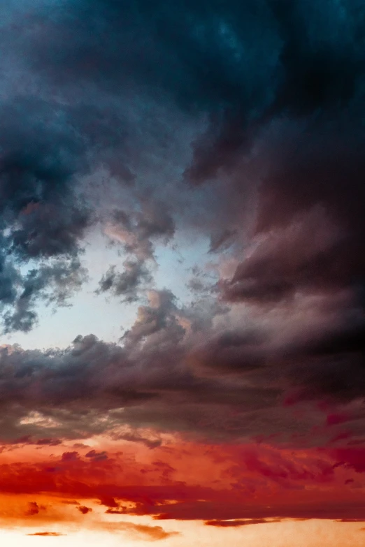 a plane flies into a cloudy sky over an open landscape