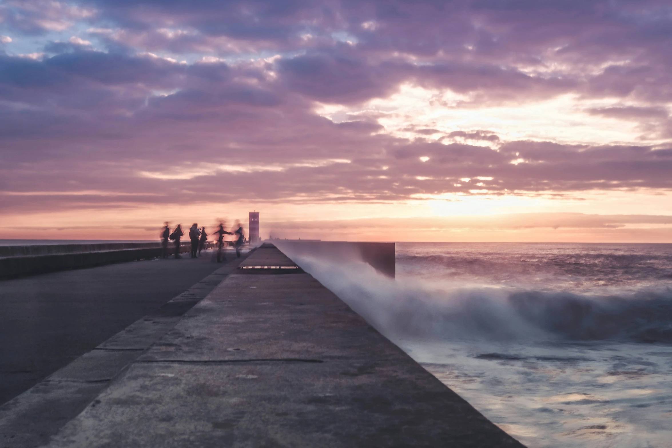 an ocean jetty with waves crashing in the shore