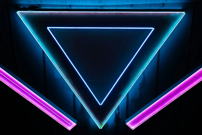 neon blue lights against a black background with triangular shapes