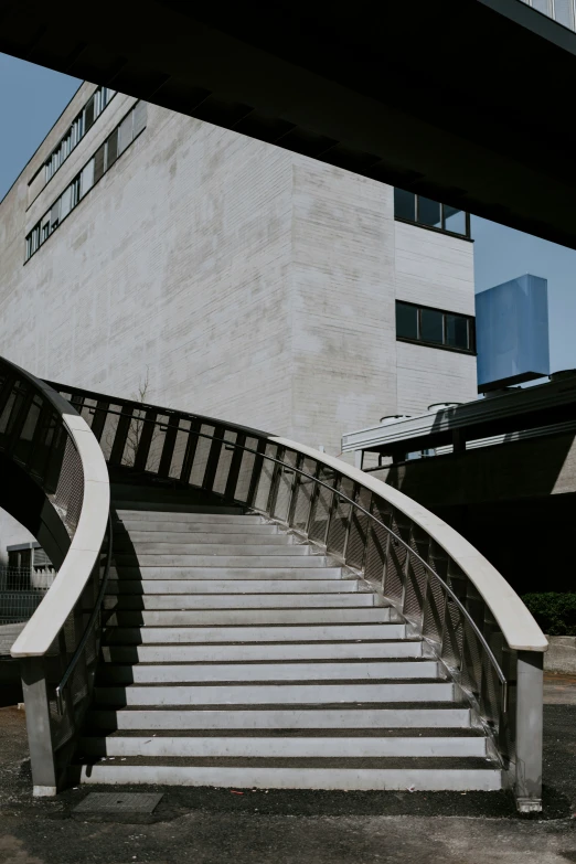 a modern staircase leading to a high building