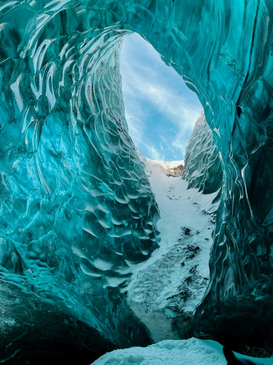 a man in the middle of an ice cave, with snow and ice chunks