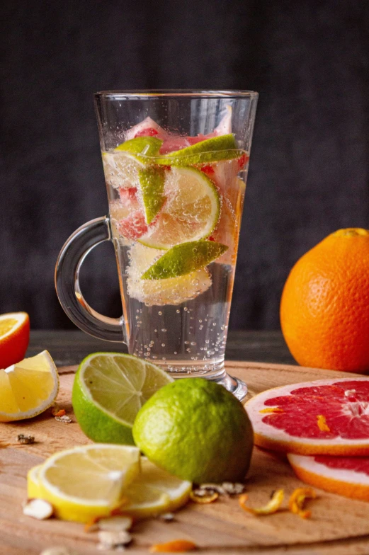 fresh fruits and water in a glass on a  board