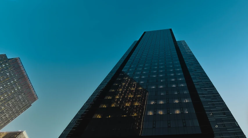 the large glass building has a small clock in the middle