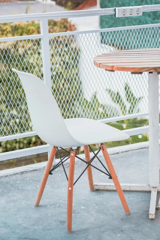 a couple of chairs are sitting outside on the patio