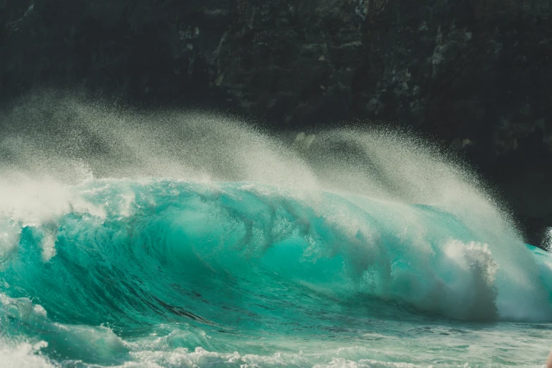 a huge wave in the ocean with lots of green paint