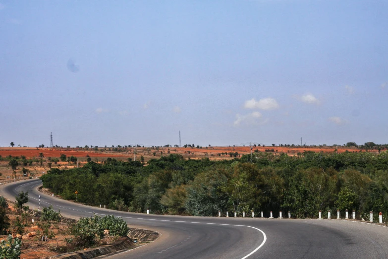 a curved road in a rural country setting