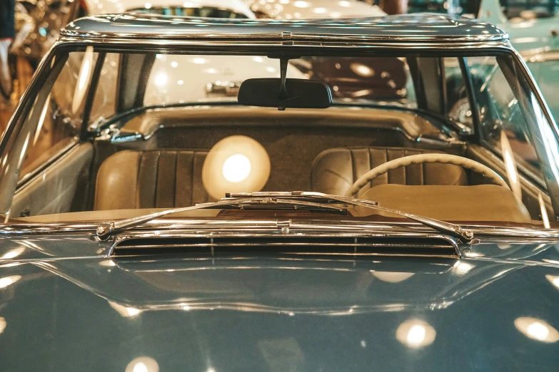 the front view of an old car inside a building