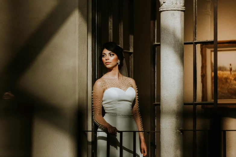 a woman is standing near an entrance to a building