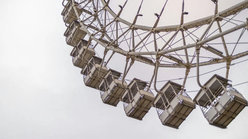 several lights hanging over a metal structure near sky