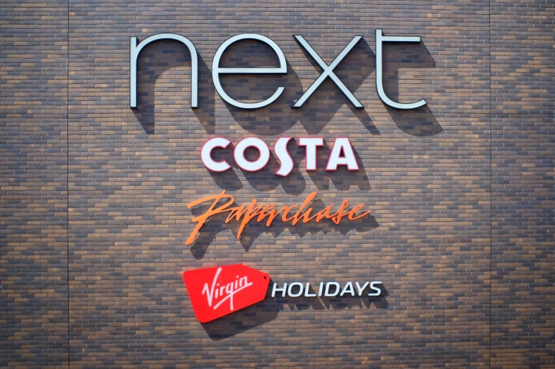 the sign for next costa is made from recycled aluminum