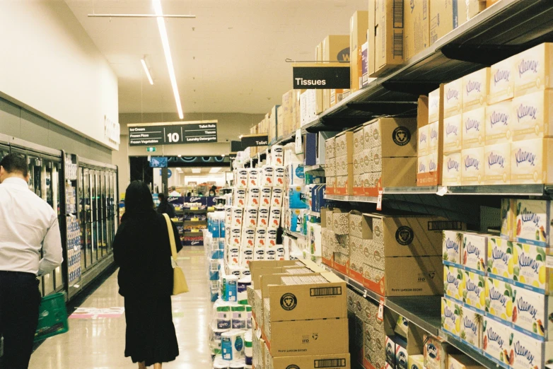 a man walks through the aisle of a supermarket aisle