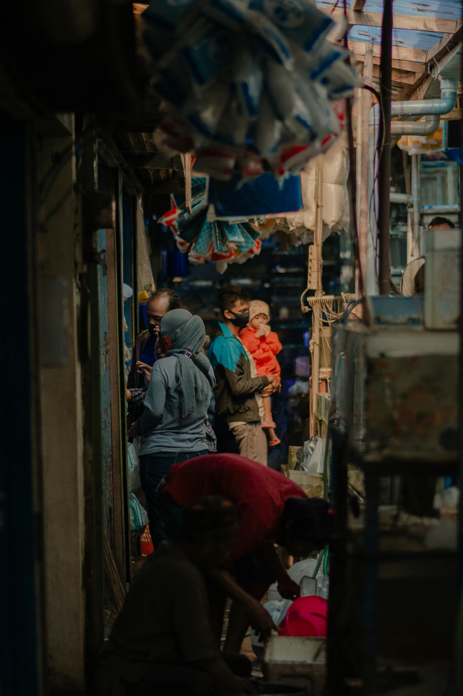 an alley way with some people walking down the street