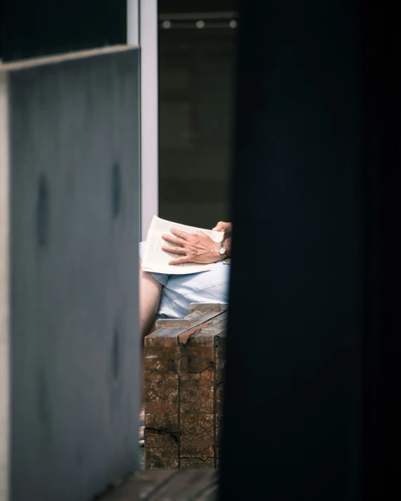 a person sitting on some bricks with a hat on