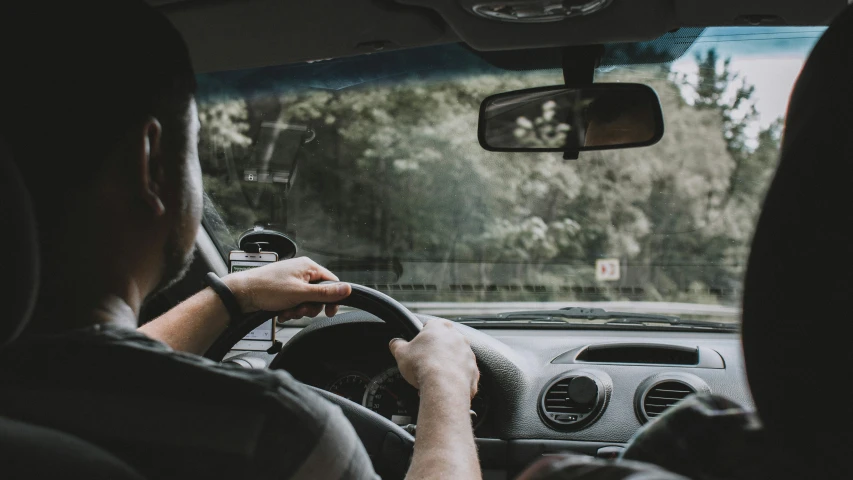 a man driving down the street in a car