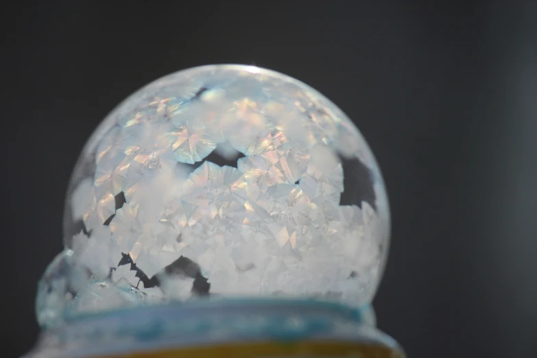 a small glass snow globe covered in snow flakes