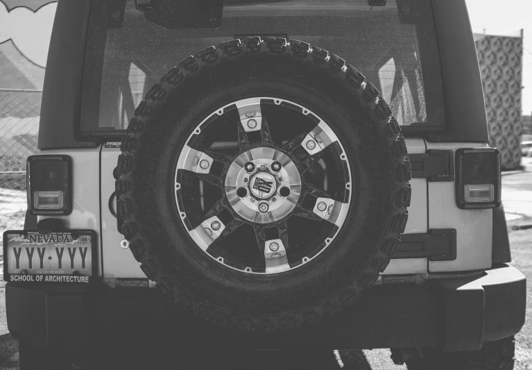 a white jeep parked next to another vehicle