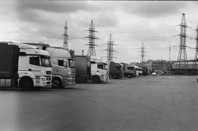 a line of trucks parked near telephone poles