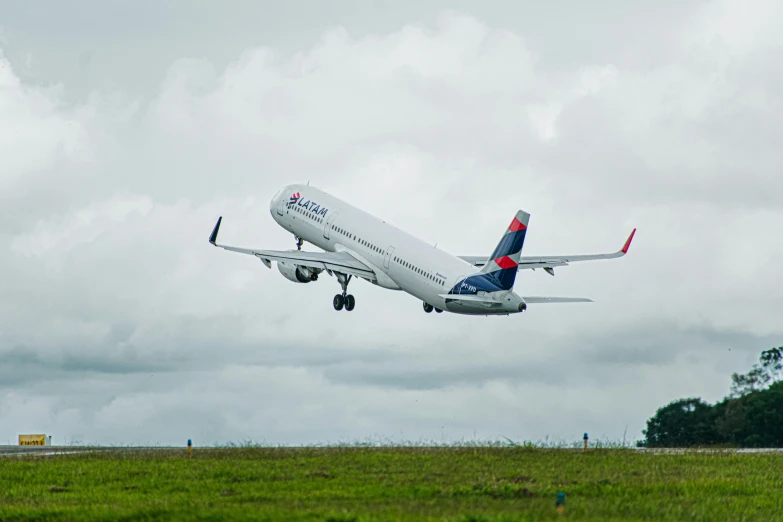 a jet airplane with landing gear down flies through the air