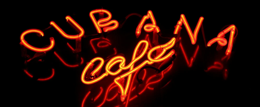 a red neon sign sitting in the corner of a store