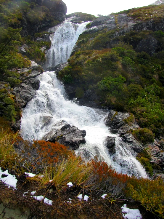 a beautiful falls can be seen between mountains