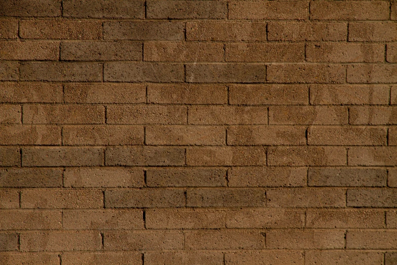 a red fire hydrant is sitting in front of a brick wall