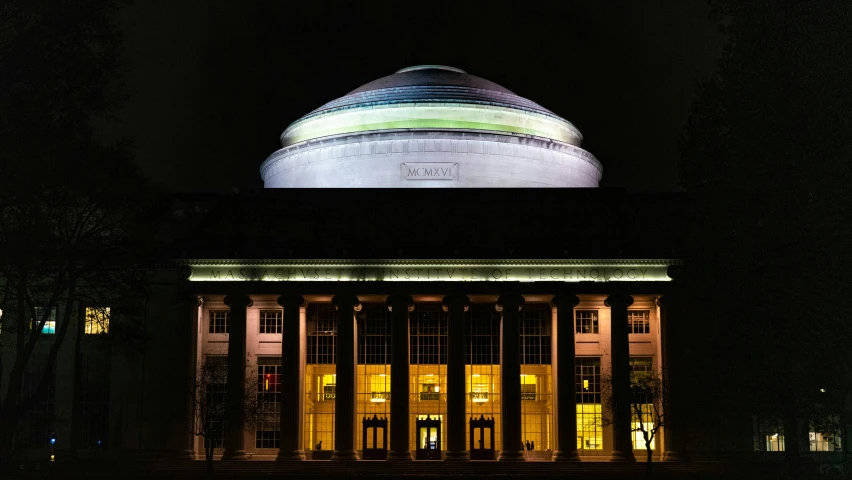 a large white round structure at night time