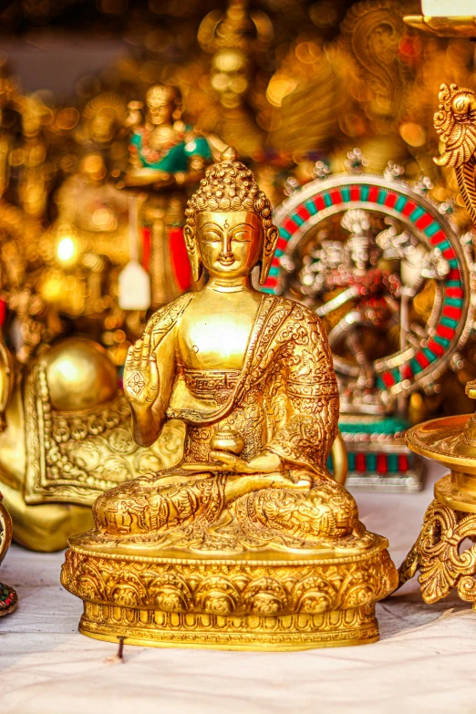 a buddha statue in a store surrounded by other objects