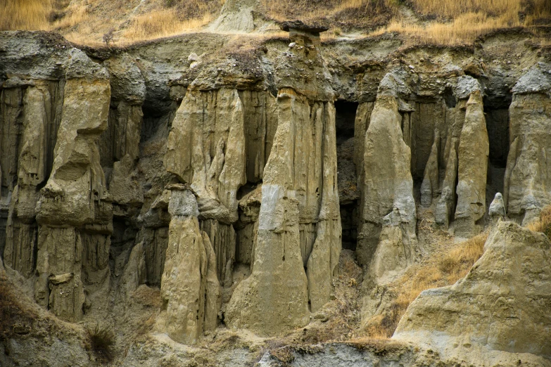 a group of people standing in front of some rocks