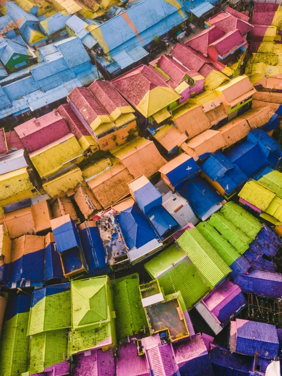 a colorful area with large colorful huts and many smaller ones