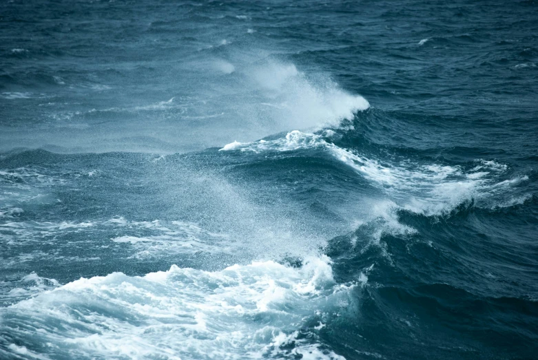 a big wave in the ocean on a cloudy day