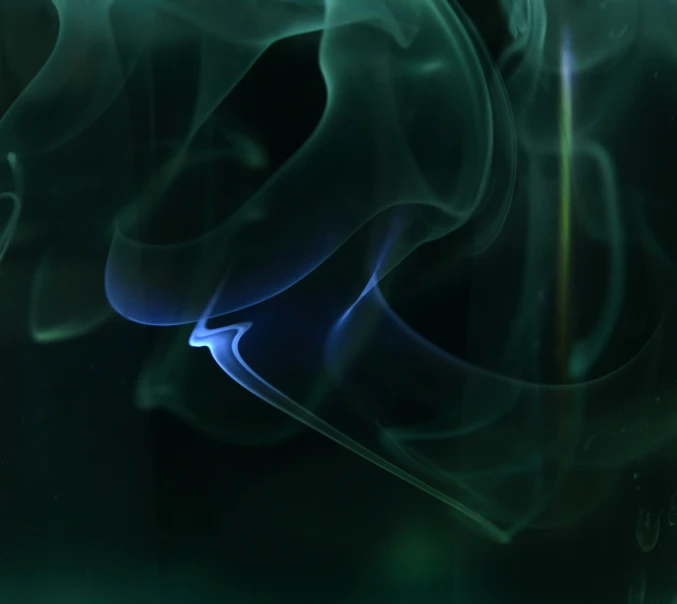 a blurry image of smoke on a dark background