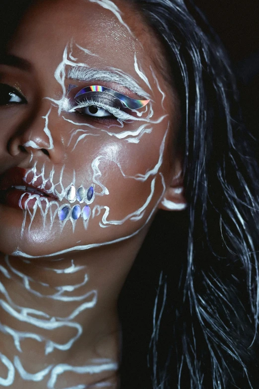 a woman has her face painted with a skeleton