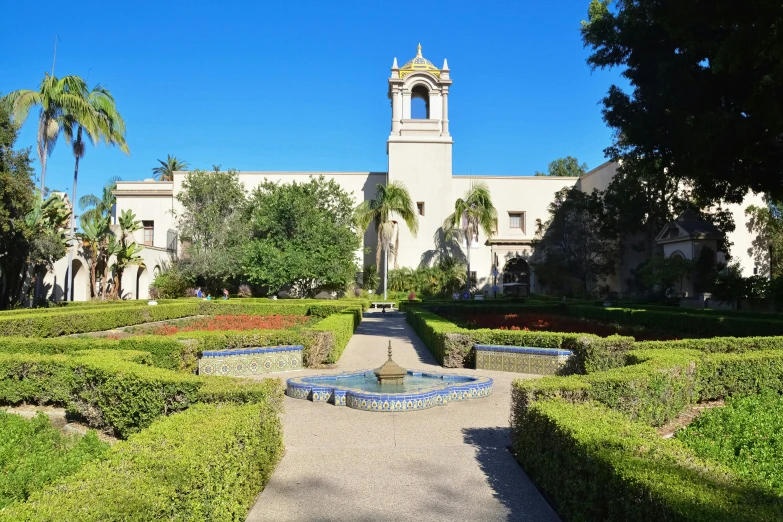 a large building with a small fountain in front