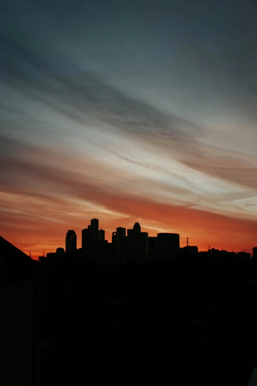 a view of a city from a rooftop with buildings in the distance