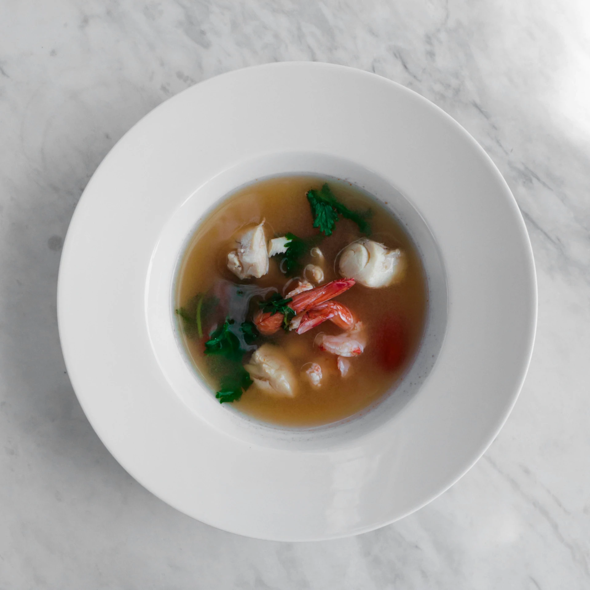 an overview of a soup is prepared and ready to be eaten